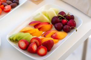 a plate of fruits and vegetables on a table at Sivota Deamaris Luxury Boutique Hotel in Syvota