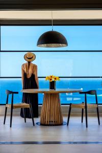 a mannequin standing next to a table with a vase on it at Tropicana Hotel , Suites & Villas Mykonos in Paradise Beach
