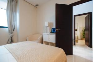 Posteľ alebo postele v izbe v ubytovaní Acogedor Apartamento José Laguillo. + 9 fotografií