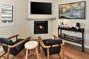 a living room filled with furniture and a fire place at Inn At Rose's Landing in Morro Bay