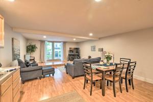 a kitchen and living room with a table and chairs at Cute Grand Haven Apartment Walk Downtown Streets! in Grand Haven