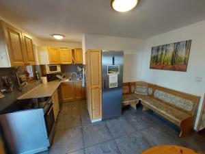 a kitchen with wooden cabinets and a blue refrigerator at Chata Kriváň - bez kontaktu s ubytovateľom "Click 'n Sleep" in Terchová
