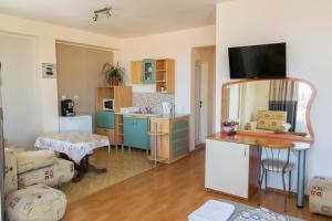a room with a kitchen and a living room at Guest house Eos in Sozopol