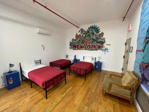 a living room filled with furniture and a red couch at NY Moore Hostel in Brooklyn