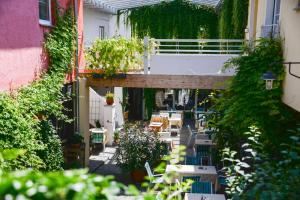 an outdoor patio with tables and chairs and plants at Gasthof Hotel Zweimüller in Grieskirchen