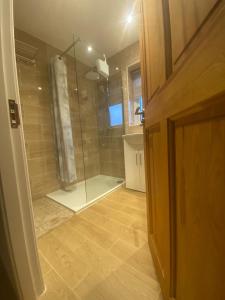 a bathroom with a shower with a glass door at RICHFLO Facility Rentals in Manchester