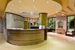 a lobby with a bar in a building at Saint George Palace Hotel All-inclusive in Sveti Vlas +19 photos