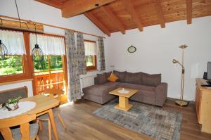 a living room with a couch and a table at Ferienwohnung Maria Erlsbacher in Sankt Veit in Defereggen