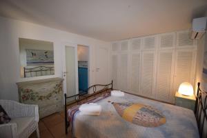 ポルト・ロトンドにあるpunta lepre 9のベッドルーム(大型ベッド1台、椅子付)