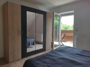 a bedroom with a large glass door and a bed at Ferienwohnung "Schwalbennest" in Motzen