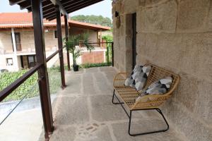 a wicker chair sitting on a patio at CASA VACACIONAL ACIO in Ourense