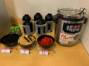 a counter top with bowls of food and a coffee maker at AZ Inn Obu - Vacation STAY 71878v in Obu