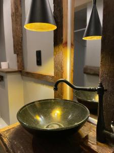 a green bowl on a table next to a lamp at Chata Rosochata in Nakwasin +15 photos