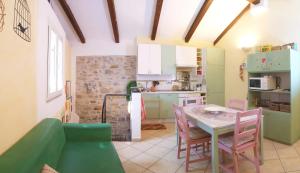 a kitchen and dining room with a table and chairs at La casa nel Caruggio in Diano Arentino