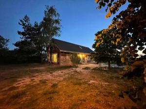 a house with a light on the side of it at night at Chata Rosochata in Nakwasin