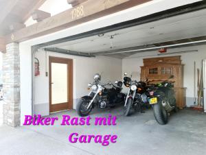 a garage with two motorcycles parked in it at Hotel Alpenhof*** in Kaltenbach