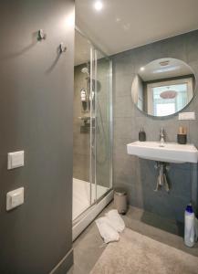 a bathroom with a shower and a sink and a mirror at Seaside apartment Albatross, spa and pool in Ķesterciems