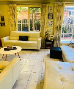 a living room with couches and a table at ABC Homes in Melbourne