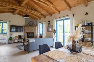 a living room with wooden ceilings and a table and chairs at Villa Toro in Motovun