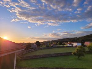 a view of the sunset from the balcony of a house at Hotel Restaurante el Fornon in Novellana