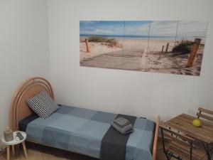 a bedroom with a bed and a picture of a beach at GRETA'S HOUSE in Comitini +22 photos