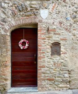 a brick building with a door with a wreath on it at Il Fienile in Garessio
