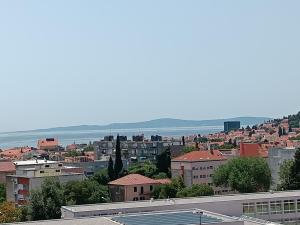 a city with buildings and the ocean in the background at Apartments Ivan & Luka in Split