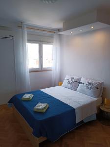 a bedroom with a bed with two towels on it at Apartments Ivan & Luka in Split