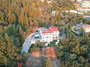 an aerial view of a house in the middle of a forest at Nikoli Apartments in Benitses