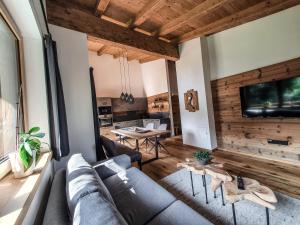 a living room with a couch and a table at Zeitfrei Chalet Apartments in Fieberbrunn