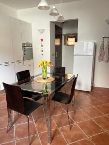 a dining room table with chairs and a vase of flowers at Il Fienile in Garessio