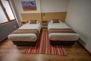 Katil atau katil-katil dalam bilik di Ayni Cusco Hotel