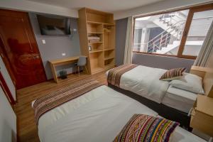 Katil atau katil-katil dalam bilik di Ayni Cusco Hotel