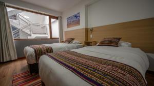 Katil atau katil-katil dalam bilik di Ayni Cusco Hotel