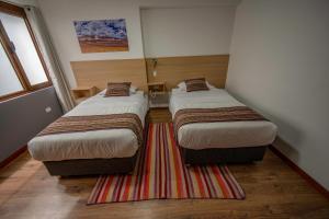 Katil atau katil-katil dalam bilik di Ayni Cusco Hotel