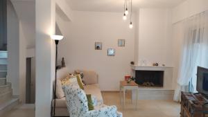 a living room with a couch and a fireplace at Sunkissed and Seasalted House in Melíssion