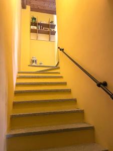 a stairway with yellow walls and yellow stairs at Il Fienile in Garessio
