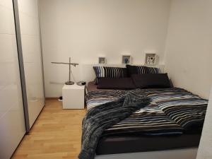 Apartment Entegast في شوبفهايم: غرفة نوم عليها سرير وبطانية