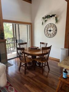 a dining room table with chairs and a clock on the wall at Indian Hills Gem Awaits in Truckee
