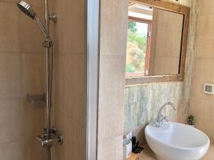 a bathroom with a sink and a shower with a mirror at Elaion mini suites in Nafplio +69 photos