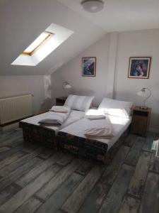 a bedroom with a large bed with two pillows at Twins in Hurbanovo