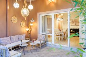 a patio with chairs and tables and a dining room at Luxury House Niso in Skala Sotiros +13 photos