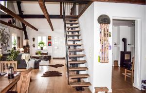 a spiral staircase in a room with a living room at 3 Bedroom Beautiful Home In Köpingebro in Köpingebro