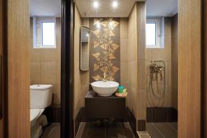 a bathroom with a sink and a toilet and a shower at Luxury House Niso in Skala Sotiros