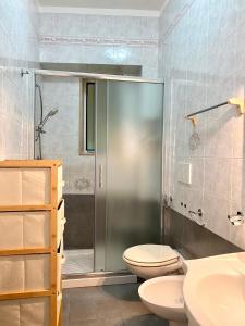 a bathroom with a shower and a toilet and a sink at La Vue est Belle - Puglia Mia Apartments in Monopoli