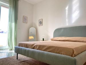a bedroom with a large bed and a mirror at La Vue est Belle - Puglia Mia Apartments in Monopoli