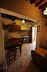 a kitchen with a table and a dining room at La Rocca della Magione in Monteriggioni