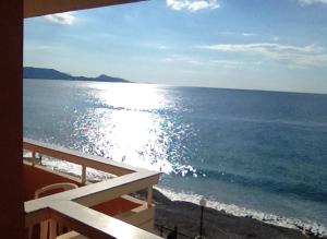 a view of the ocean from a balcony at 4 Brothers in Rhodes Town