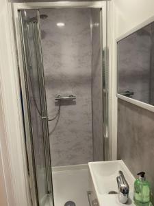 a bathroom with a shower and a sink at Luton Short Term Lets - Cardiff Road in Luton