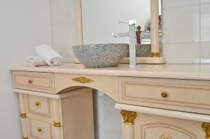 a bathroom counter with a sink and a mirror at Apartments Rajsko Mjesto in Tivat